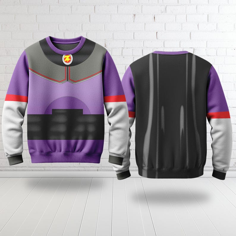May include: A purple sweatshirt with a design inspired by a space ranger uniform. The front features a gray chest piece, red accents, and a yellow and red emblem. The back is black with vertical gray stripes. White sleeves with red stripes.