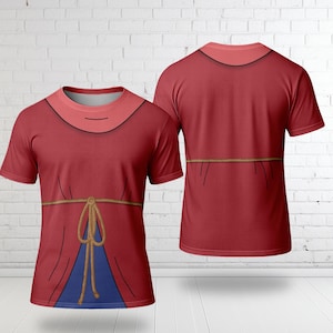 May include: Red t-shirt with a design resembling a medieval tunic. The shirt features a high neckline, a rope belt, and a blue panel at the bottom. The back of the shirt is also visible, showing the same design.