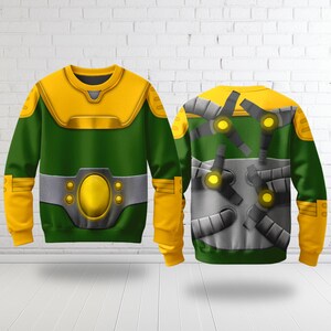 Puede incluir: Sudadera verde y amarilla con un dise&ntilde;o que se asemeja a un disfraz de superh&eacute;roe. La parte delantera presenta una pieza de pecho y cintur&oacute;n amarillos, mientras que la parte trasera muestra brazos mec&aacute;nicos. Las mangas y la parte superior del pecho son amarillas, y el cuerpo es verde.