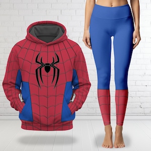 May include: A red and blue hooded sweatshirt featuring a black spider emblem and a web pattern, paired with matching blue leggings that have red web-patterned cuffs. The hoodie has a grey interior lining and blue side panels on the front.