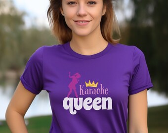 May include: Purple t-shirt with a pink silhouette of a woman singing into a microphone with a gold crown above her head. The text "Karaoke queen" is printed on the shirt in white.