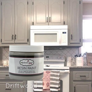 May include: A jar of gray paint labeled "Rethunk Junk Resin Paint" with the color name "Driftwood".