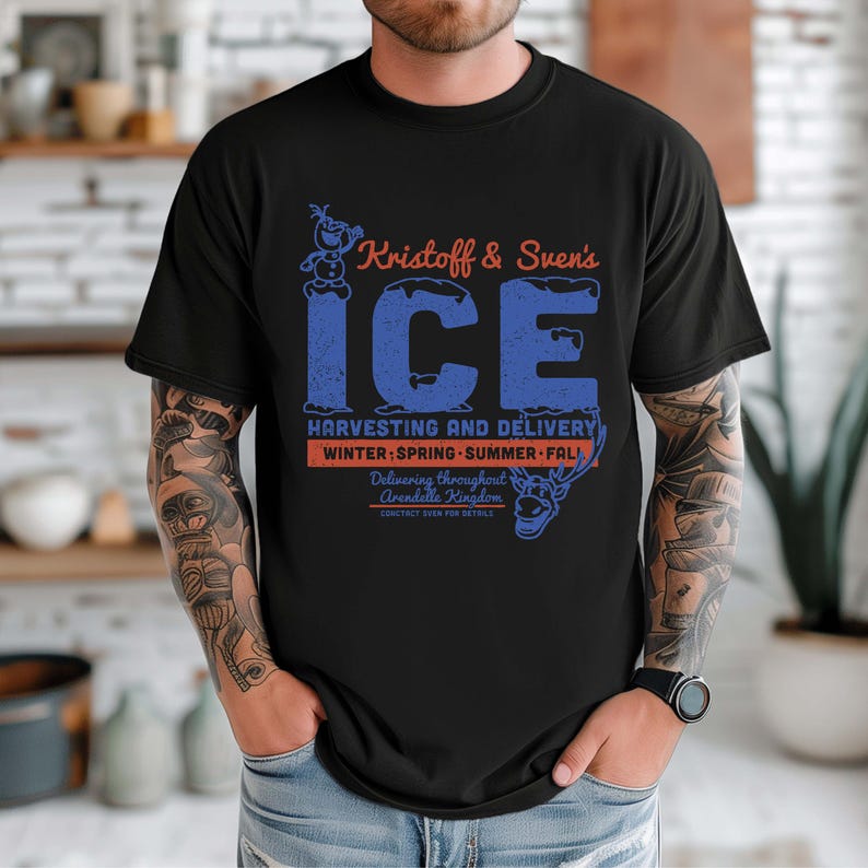 May include: Black t-shirt featuring the text "Kristoff & Sven's ICE" in blue and orange. The design includes images of Olaf and Sven, with text indicating ice harvesting and delivery throughout Arendelle Kingdom. The shirt is a crew neck.