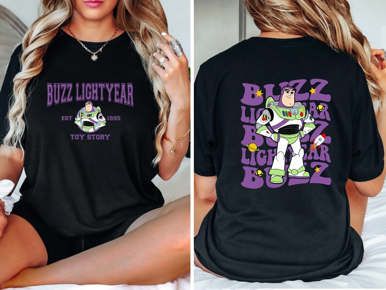 May include: Black t-shirt with a purple and white graphic of Buzz Lightyear from Toy Story. The front of the shirt says "Buzz Lightyear Est. 1995 Toy Story". The back of the shirt says "Buzz Lightyear Buzz" in a retro font.