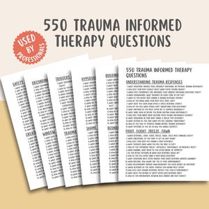 May include: A stack of white cards with black text, titled "550 Trauma Informed Therapy Questions." The cards are organized by topic, including "Safety," "Triggers," and "Understanding Trauma Responses." A red circle with white text reads "Used by Professionals."