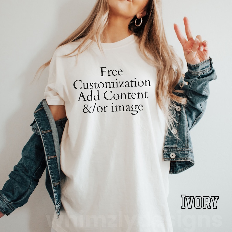 May include: A white t-shirt with the text "Free Customization Add Content &/or image" printed on the front. The t-shirt is being worn by a person and the word "IVORY" is printed in black on the bottom right corner of the image.