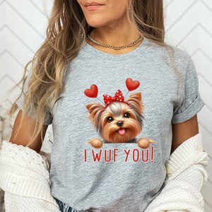 May include: Gray t-shirt with a cartoon Yorkshire Terrier wearing a red bow and red heart balloons. The text "I WUF YOU!" is printed below the dog.