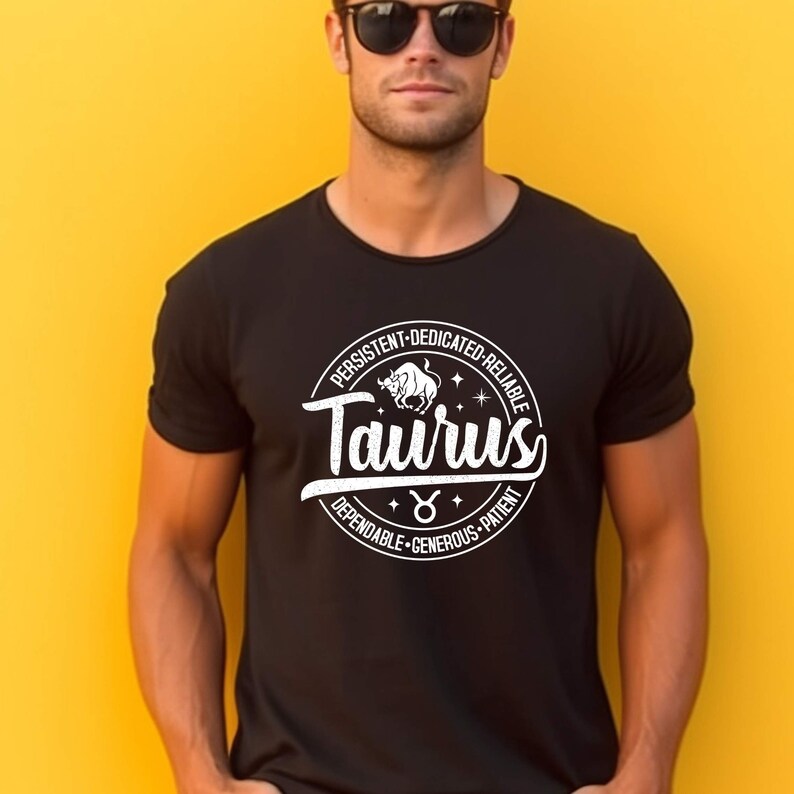 May include: Black t-shirt with a white circle graphic featuring the Taurus zodiac sign and the words "Taurus", "Persistent", "Dedicated", "Reliable", "Dependable", "Generous", and "Patient".