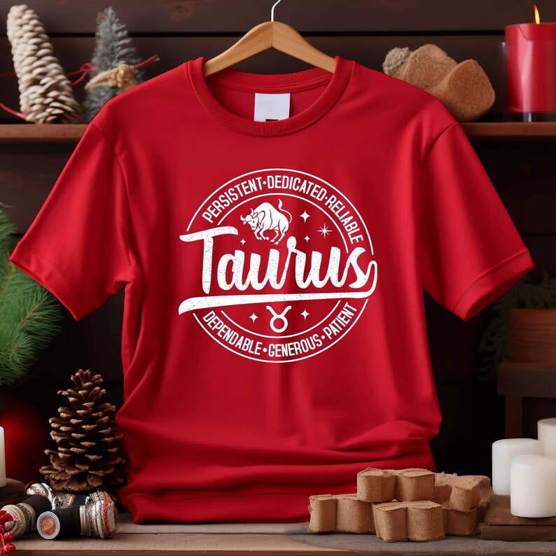 May include: Red t-shirt with a white circle graphic featuring the Taurus zodiac sign and the words "Taurus", "Persistent", "Dedicated", "Reliable", "Dependable", "Generous", and "Patient".