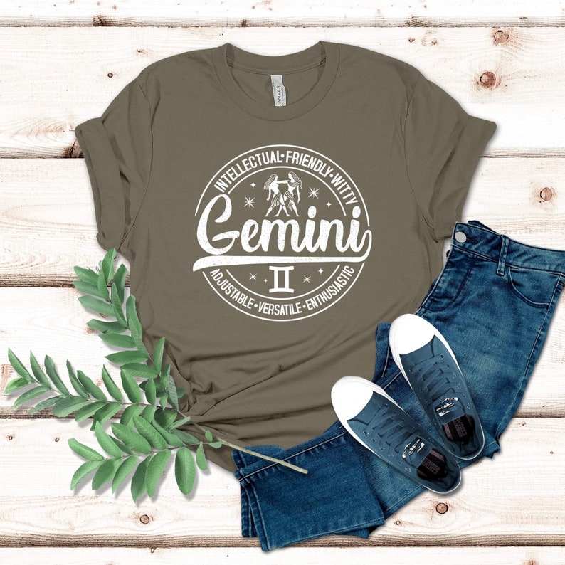 May include: A green t-shirt with a white circle graphic featuring the Gemini zodiac sign and the text "Gemini II Intellectual-Friendly-Witty Adjustable-Versatile-Enthusiastic".