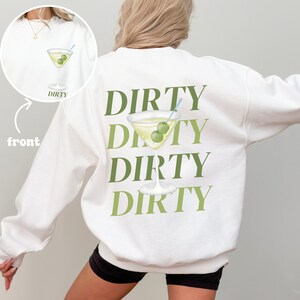 May include: White sweatshirt with the text "DIRTY" repeated four times in green, with a martini glass and olives in between each word.
