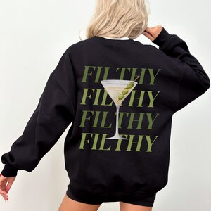May include: Black sweatshirt with a green graphic of a martini glass with olives and the word "FILTHY" repeated four times.