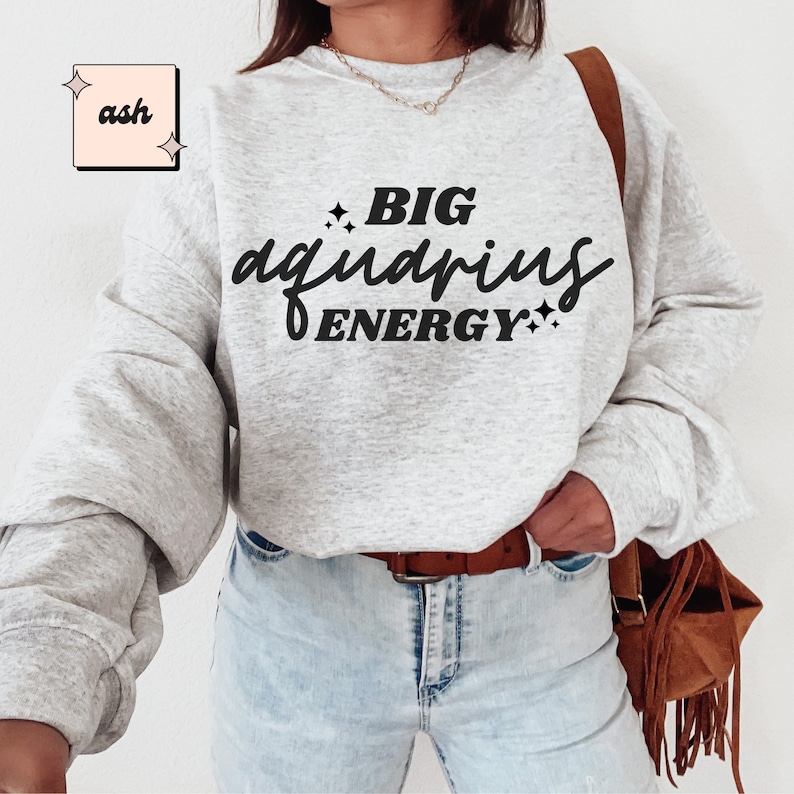 May include: A grey sweatshirt with the text "BIG aquarius ENERGY" printed in black.
