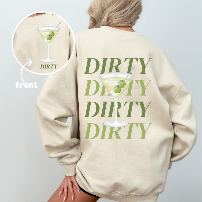 May include: A beige sweatshirt with the word "DIRTY" repeated four times in green text on the back. A martini glass with olives is printed in the center of the text.