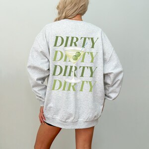 May include: A gray sweatshirt with a green graphic of a martini glass with olives and the word "DIRTY" repeated four times.