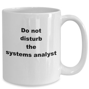 Könnte beinhalten: Weiße Keramik-Kaffeetasse mit schwarzem Text, der "Bitte nicht stören, Systemadministrator" lautet.