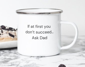 May include: White enamel mug with a silver rim and a black inscription that reads "If at first you don't succeed... Ask Dad".
