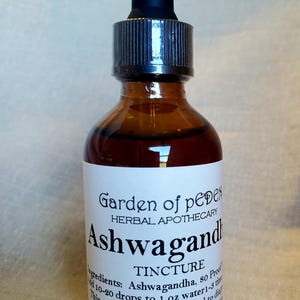 May include: A brown glass bottle with a dropper top, labelled "Garden of Eden Herbal Apothecary Ashwagandha Tincture". The label also includes the ingredients, dosage instructions, and a disclaimer that the product is not intended to diagnose, treat, cure, or prevent any disease. The bottle contains 2 ounces (60 ml) of liquid.