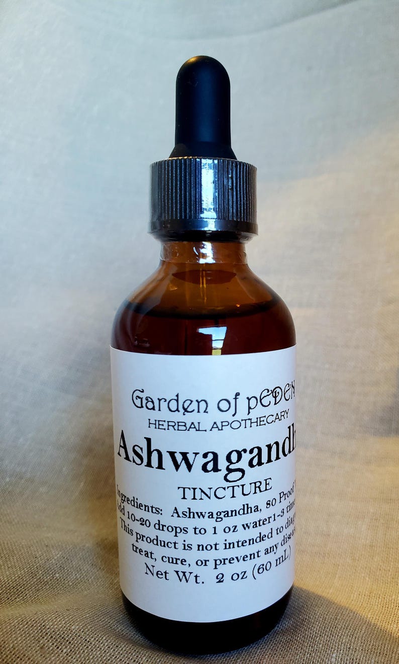 May include: A brown glass bottle with a dropper top, labelled "Garden of Eden Herbal Apothecary Ashwagandha Tincture". The label also includes the ingredients, dosage instructions, and a disclaimer that the product is not intended to diagnose, treat, cure, or prevent any disease. The bottle contains 2 ounces (60 ml) of liquid.