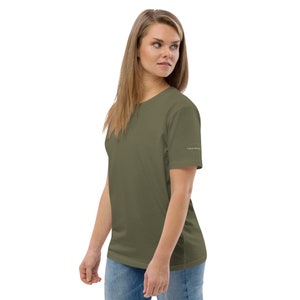 May include: A green short-sleeved t-shirt with a small white logo on the right sleeve.
