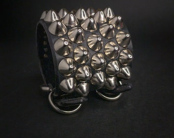 Studded leather wristband cuff. Staggered 5-row standard 77 cone studs spikes.