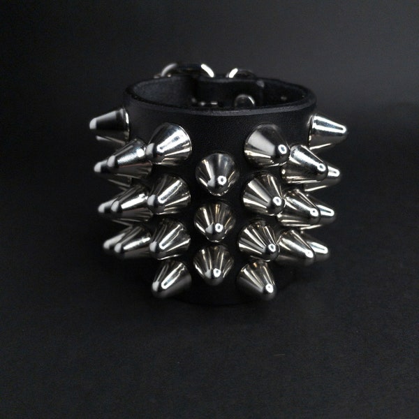 Handmade studded leather wristband cuff bracelet. 4-3-4 tall British 77 cone studs spikes.