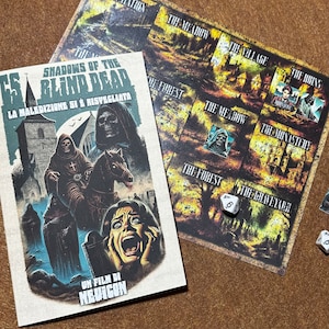 May include: A board game with a map of a village, forest, and graveyard. The game is called "Shadows of the Blind Dead" and the text "La Maledizione Si È Risvegliata" is also on the board. There are dice on the board, one with the number 6 on it.