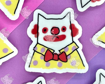 May include: Five stickers of a white cat wearing a yellow shirt with purple polka dots and a red bow tie. The cat has a red nose and red clown makeup around its eyes and mouth.