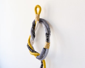 Knot wrapped macrame wall hanging, Decorative rope knot in yellow and grey, Large wrapped fiber art for interior decor
