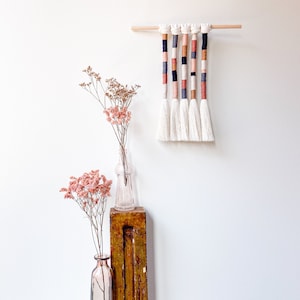 Boho fringed wall hanging in earthy colors, Wrapped rope decor with fringe, Mural macrame tassels for home interior