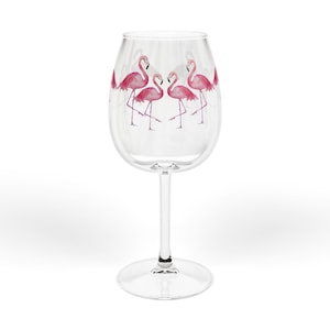 May include: A clear wine glass with a long stem and a round base. The glass is decorated with a watercolor design of pink flamingos. The flamingos are in various poses, adding a touch of whimsy to the glassware.