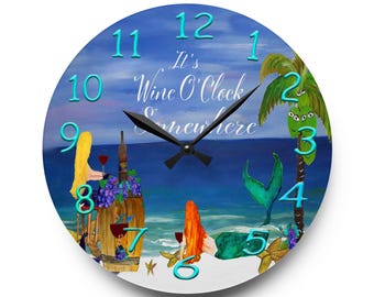 May include: A round wall clock featuring a beach scene with a blonde figure, a mermaid with red hair, a wine barrel, and a palm tree. The text reads It's Wine O'Clock Somewhere. The clock has black hands and large, raised, bright blue numbers.