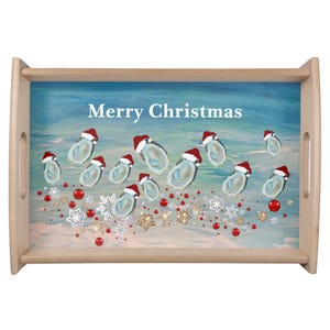 May include: Wooden serving tray with a festive design. The tray features the text "Merry Christmas" above illustrations of oysters wearing Santa hats, red ornaments, and snowflakes. The background is a blue and white watercolor design.