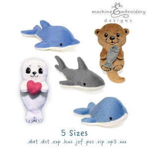 May include: Five plush-style machine embroidery designs featuring a blue dolphin, a brown otter holding a fish, a white seal holding a pink heart, a gray shark, and a blue whale. Text reads machine embroidery designs, 5 Sizes, and file formats.