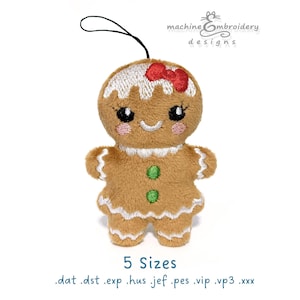 May include: A brown gingerbread person plush ornament with white icing details, a red bow on the head, pink cheeks, and two green buttons on the torso. The design includes a black hanging loop and text reading machine embroidery designs 5 Sizes.