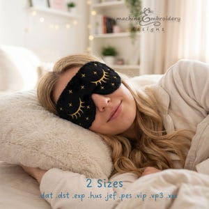 May include: A black sleep mask featuring gold embroidered closed eyes with long lashes and small star accents. The mask is designed for machine embroidery and is available in 2 sizes with file formats including .dat, .dst, .exp, .hus, .jef, .pes, .vip, .vp3, and .xxx.