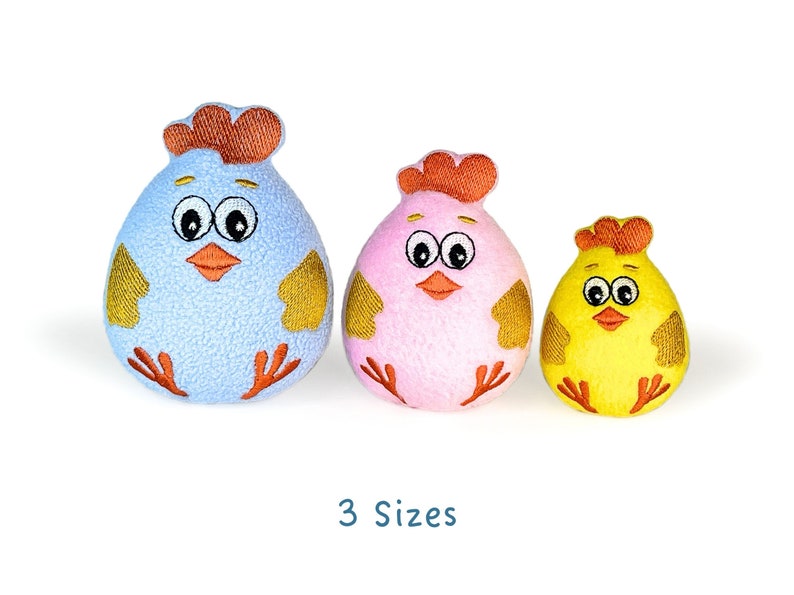 May include: Three plush chick toys in different sizes. The largest chick is light blue with yellow accents, the middle chick is pink with yellow accents, and the smallest chick is yellow with orange accents.  All three chicks have embroidered eyes and beaks.