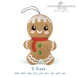 Puede incluir: Adorno de hombre de jengibre de peluche con bufanda roja y botones verdes. El hombre de jengibre tiene detalles de glaseado blanco y una cara sonriente. El adorno tiene una cuerda negra para colgar. El texto "machine embroidery designs" está en la parte superior.