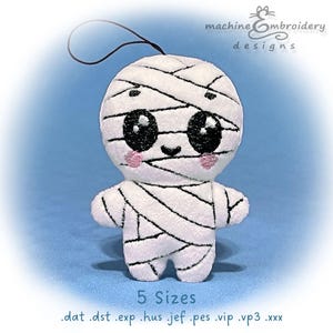 May include: A plush mummy toy with a black string for hanging. The white mummy is wrapped in black bandages, has large black eyes, pink cheeks, and a small smile. The text "5 Sizes" and file extensions are at the bottom.
