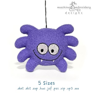 May include: A purple felt monster toy with embroidered features, including eyes, mouth, and fangs. It has six limbs and is suspended by a black string. The text "5 Sizes" and file extensions are at the bottom. The top right corner has the text "machine embroidery designs".