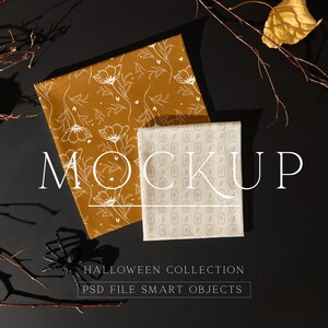 May include: Two fabric swatches with Halloween-themed patterns. The top swatch is a brown fabric with a white floral design. The bottom swatch is a white fabric with a repeating pattern of small, white pumpkins. The text "MOCKUP" is written in white letters on a black background. The text "HALLOWEEN COLLECTION" and "PSD FILE SMART OBJECTS" is written in white letters on a black background.