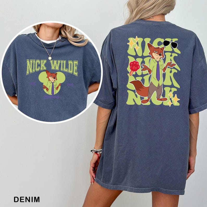 A denim t-shirt with a graphic of a cartoon fox character and text that says "NICK WILDE" and "2010".