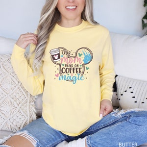a woman sitting on a couch wearing a yellow shirt