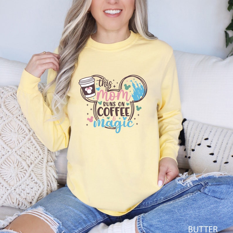 a woman sitting on a couch wearing a yellow shirt