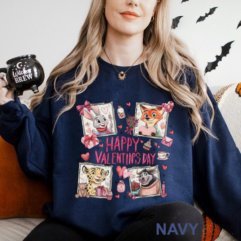 A woman wearing a navy blue sweatshirt with a graphic design featuring cartoon animal characters and the text "Happy Valentine's Day".
