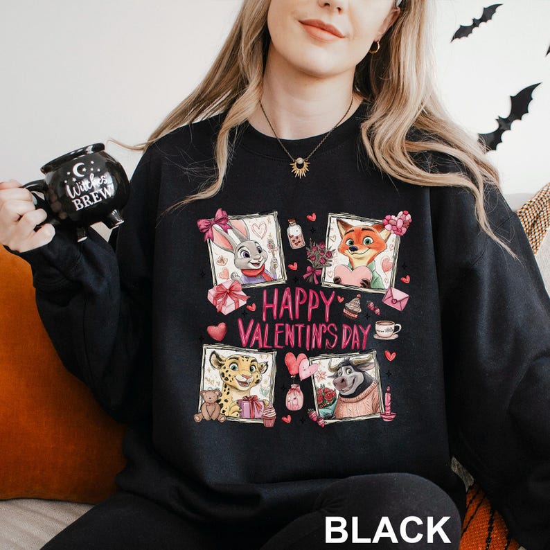 A woman wearing a black sweatshirt with a graphic design featuring cartoon animals and the text "Happy Valentine's Day".