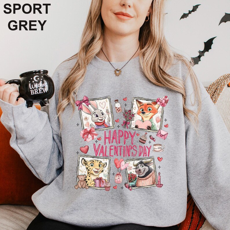 A woman wearing a grey sweatshirt with a graphic design featuring cartoon animal characters and the text "Happy Valentine's Day".