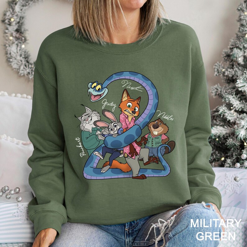 A woman wearing a green sweatshirt with a cartoon character design on it.