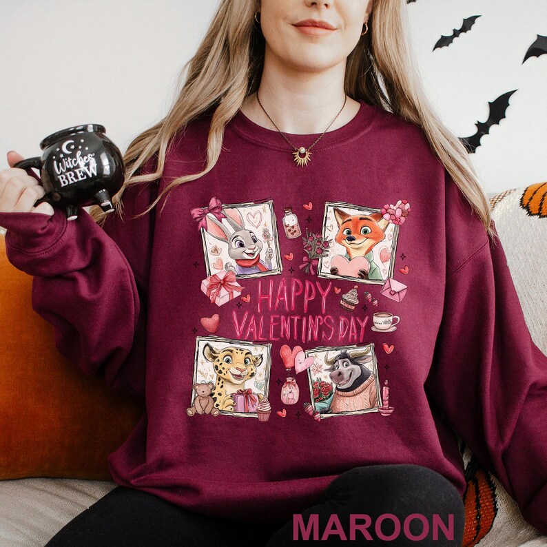 A woman wearing a maroon sweater with a graphic design featuring cartoon animal characters and the text "Happy Valentine's Day".