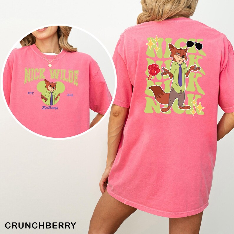 A pink t-shirt with a cartoon image of a fox wearing sunglasses and holding a red flower.